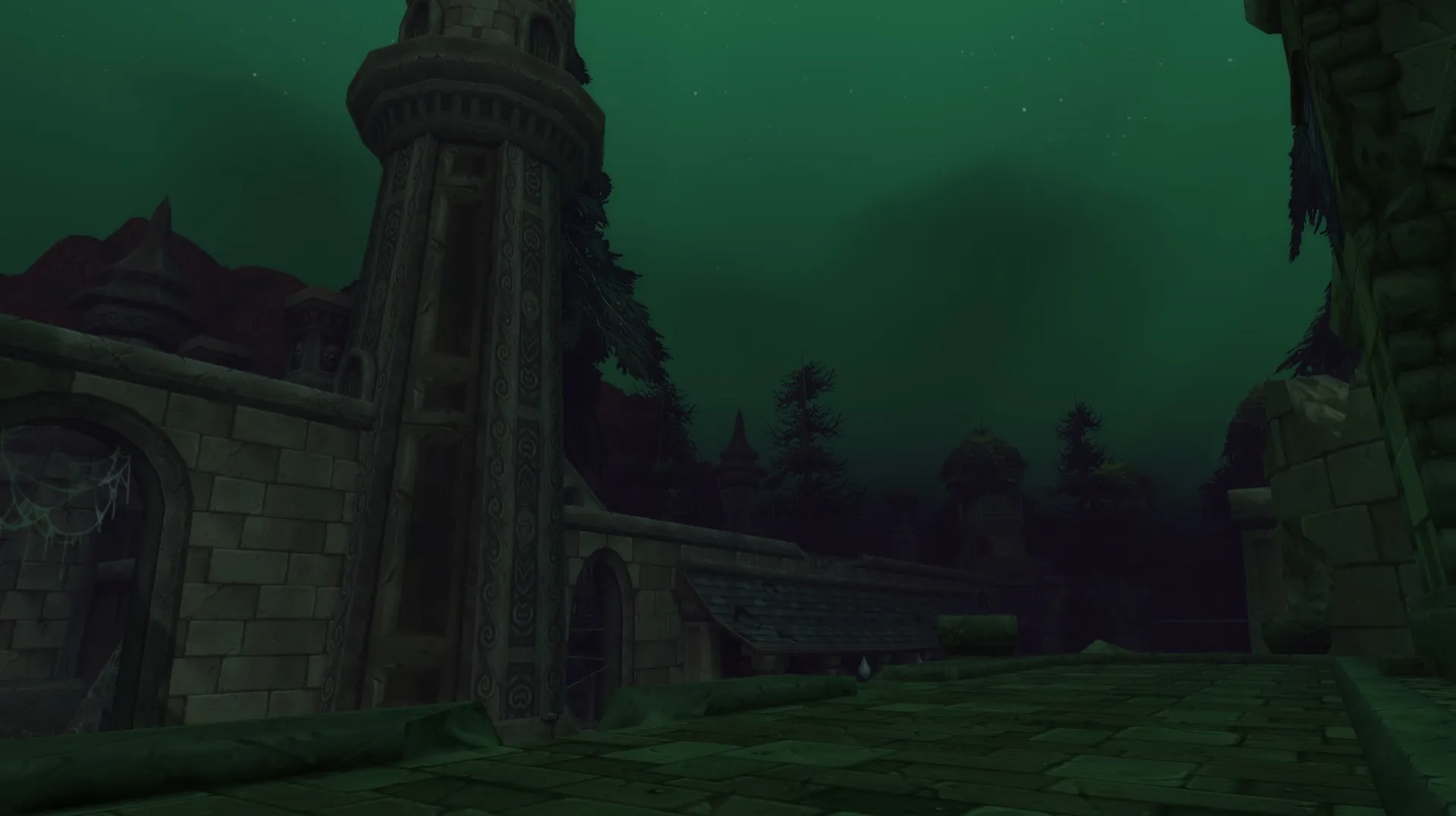 A ruined street of Lordaeron under a green night sky, with a broken tower and dead trees, a screenshot from the beta of World of Warcraft: Forever