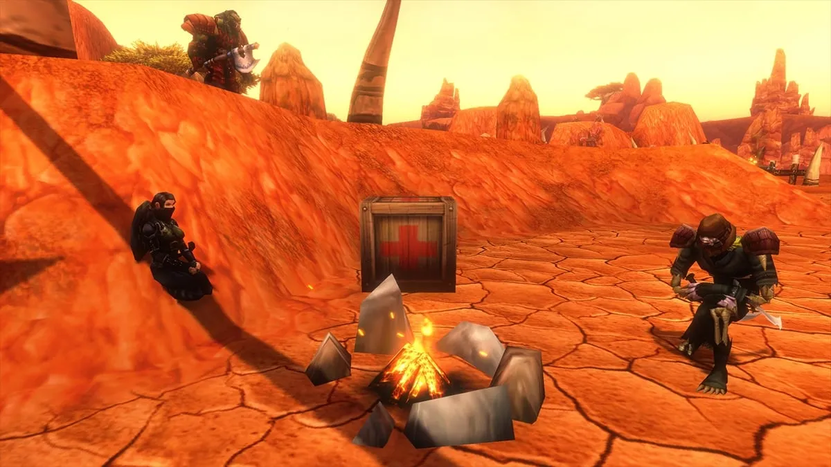 Three players resting at a campfire with a first aid kit in the red dust of Durotar, a screenshot from the beta of World of Warcraft: Forever