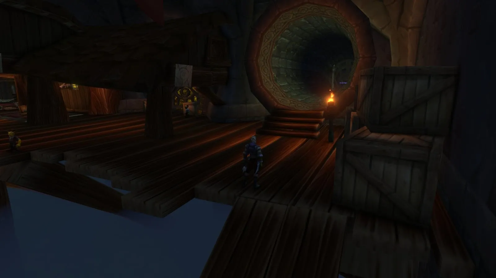 A wide sewer pipe behind wooden crates in the Dalaran Sewers, the way in for the Alliance, a screenshot from the beta of World of Warcraft: Forever