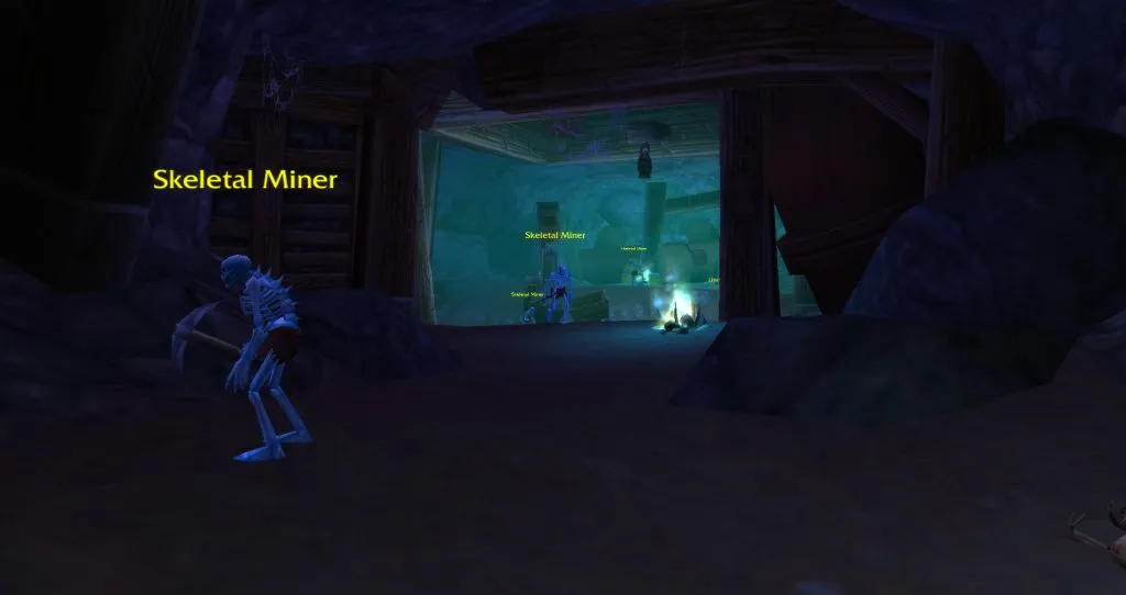 The haunted part of the mine outside the Deadmines, with undead miners between the beams, a screenshot from World of Warcraft