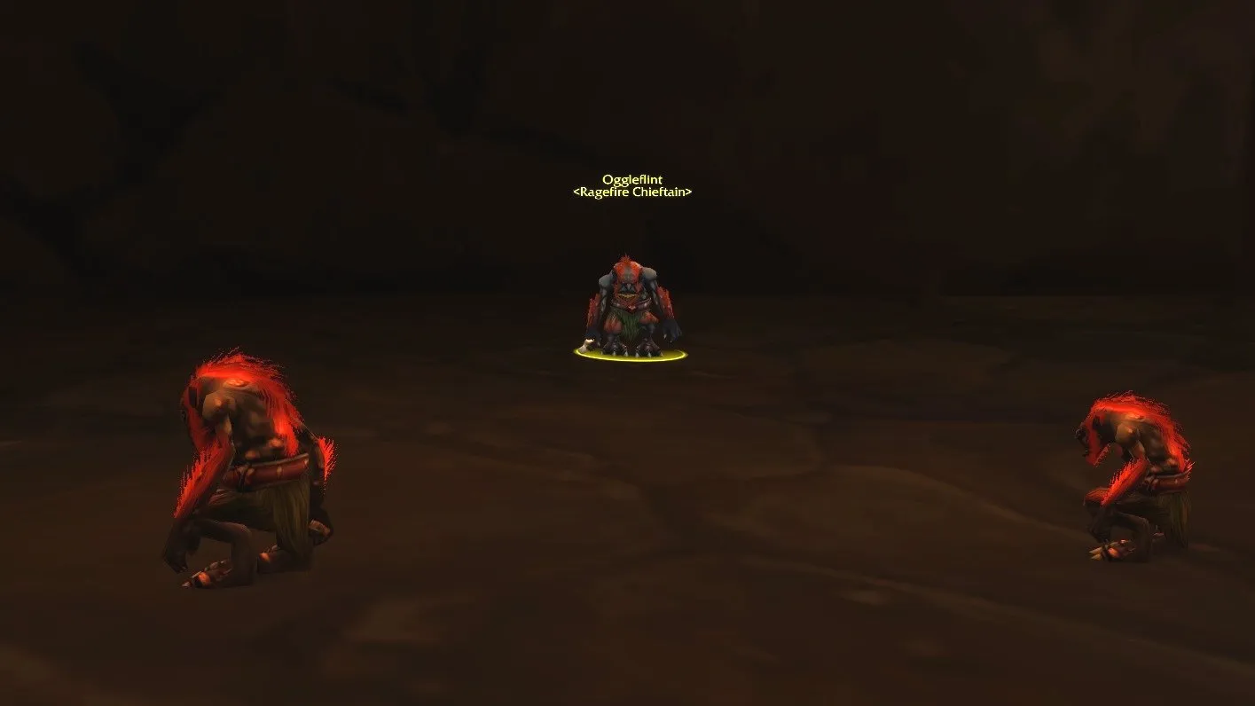 Oggleflint between two troggs in a dark cave of Ragefire Chasm, a screenshot from World of Warcraft