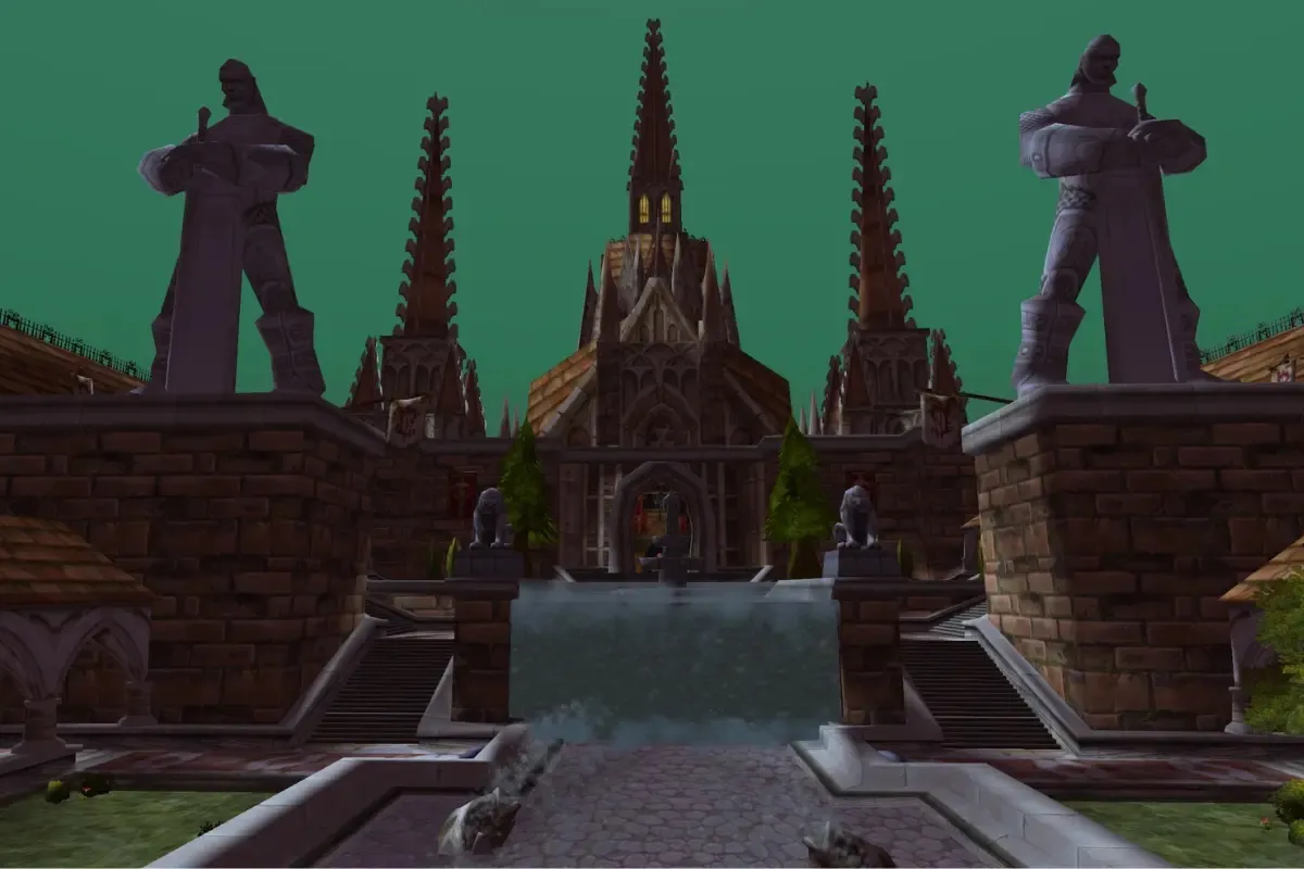 The courtyard of the Scarlet Monastery with its pond, two statues and the cathedral, a screenshot from World of Warcraft