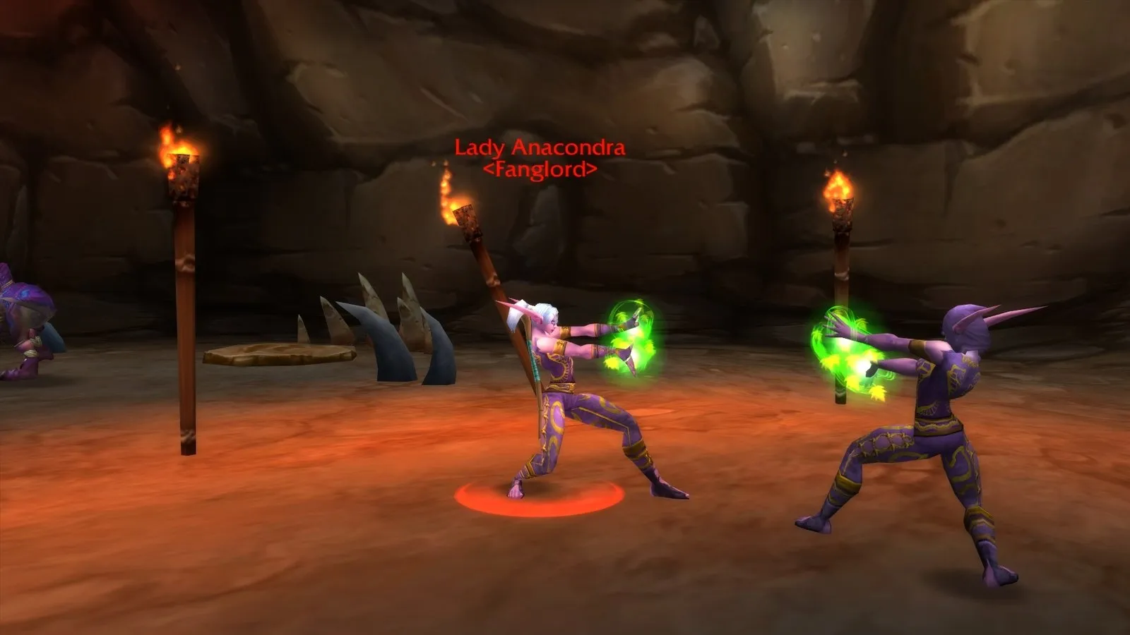 Lady Anacondra and a Druid of the Fang between torches in Wailing Caverns, a screenshot from World of Warcraft