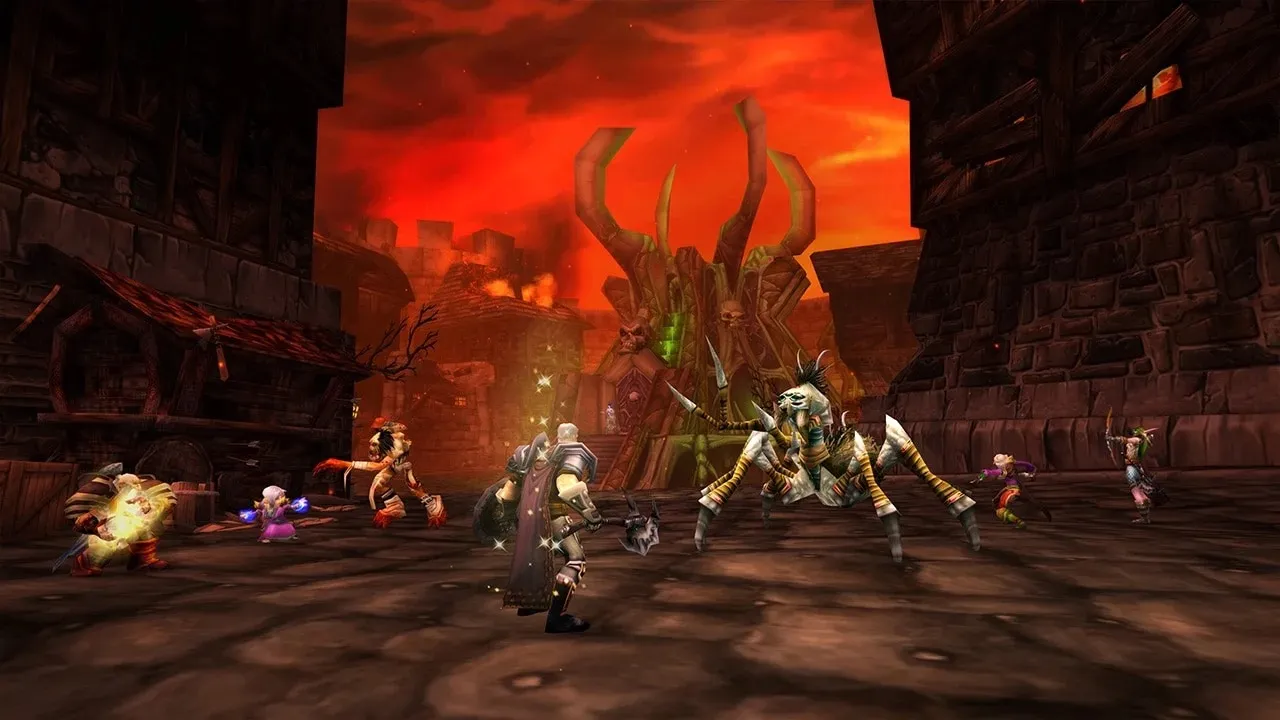 Un groupe de joueurs combat des squelettes et une abomination dans les rues en flammes de Stratholme, une capture d’écran de World of Warcraft