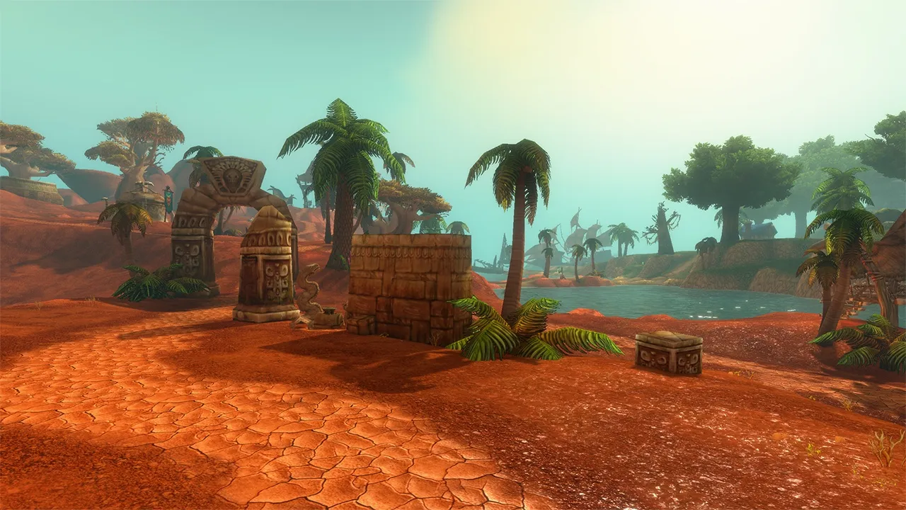Ruins of carved stone on a red, cracked road next to a lagoon with palm trees, an official screenshot of World of Warcraft: Forever