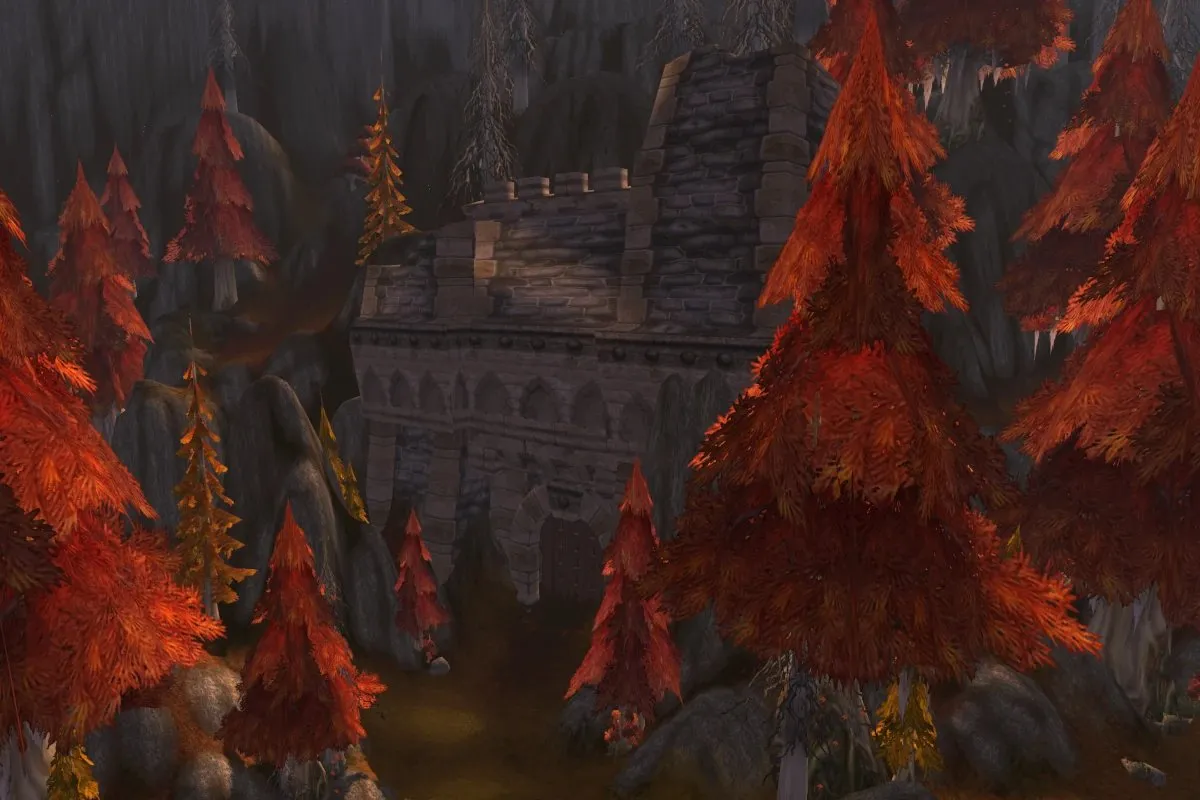 A large stone gate between red autumn trees against a rock wall in Azshara, a screenshot from World of Warcraft: Forever