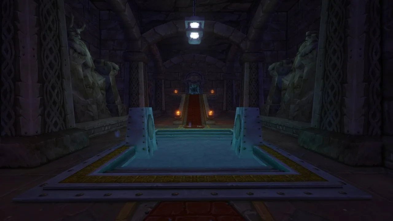 A dark dwarven hall with a stone pool, carved dwarf statues on both sides and a red carpet up to a stair, an in-game screenshot
