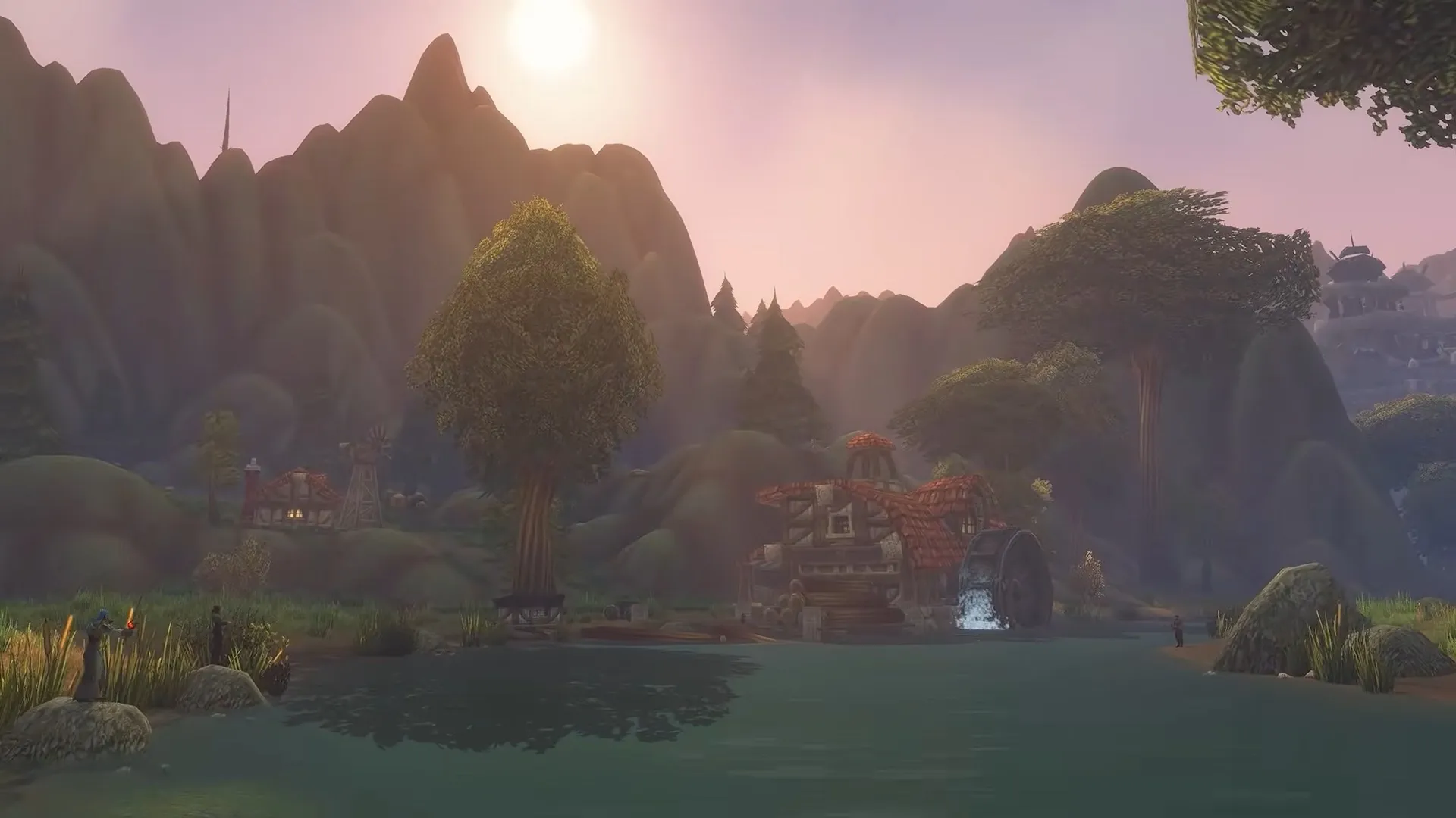 Eine Mühle mit Wasserrad an einem See, mit Bauernhäusern und Bergen im rosa Abendlicht, ein Screenshot aus World of Warcraft: Forever