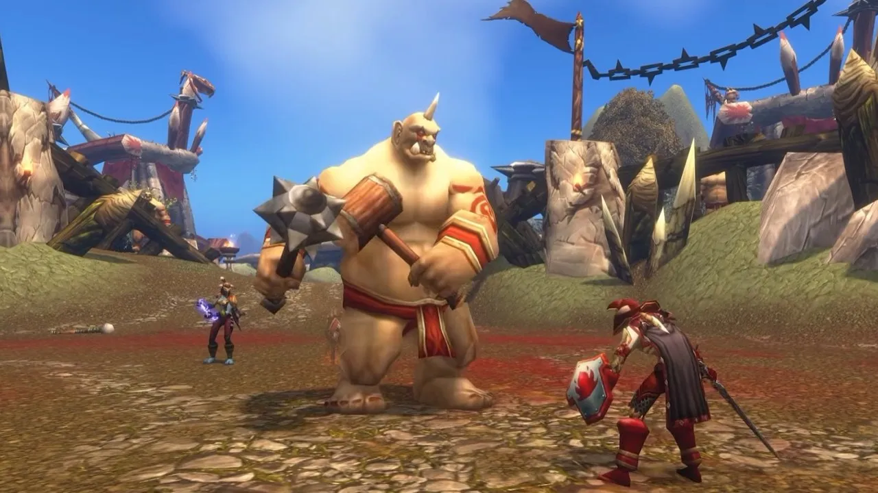 A large ogre with a spiked hammer faces a player with a sword and shield in a fighting pit, from Blizzard's video about World of Warcraft: Forever