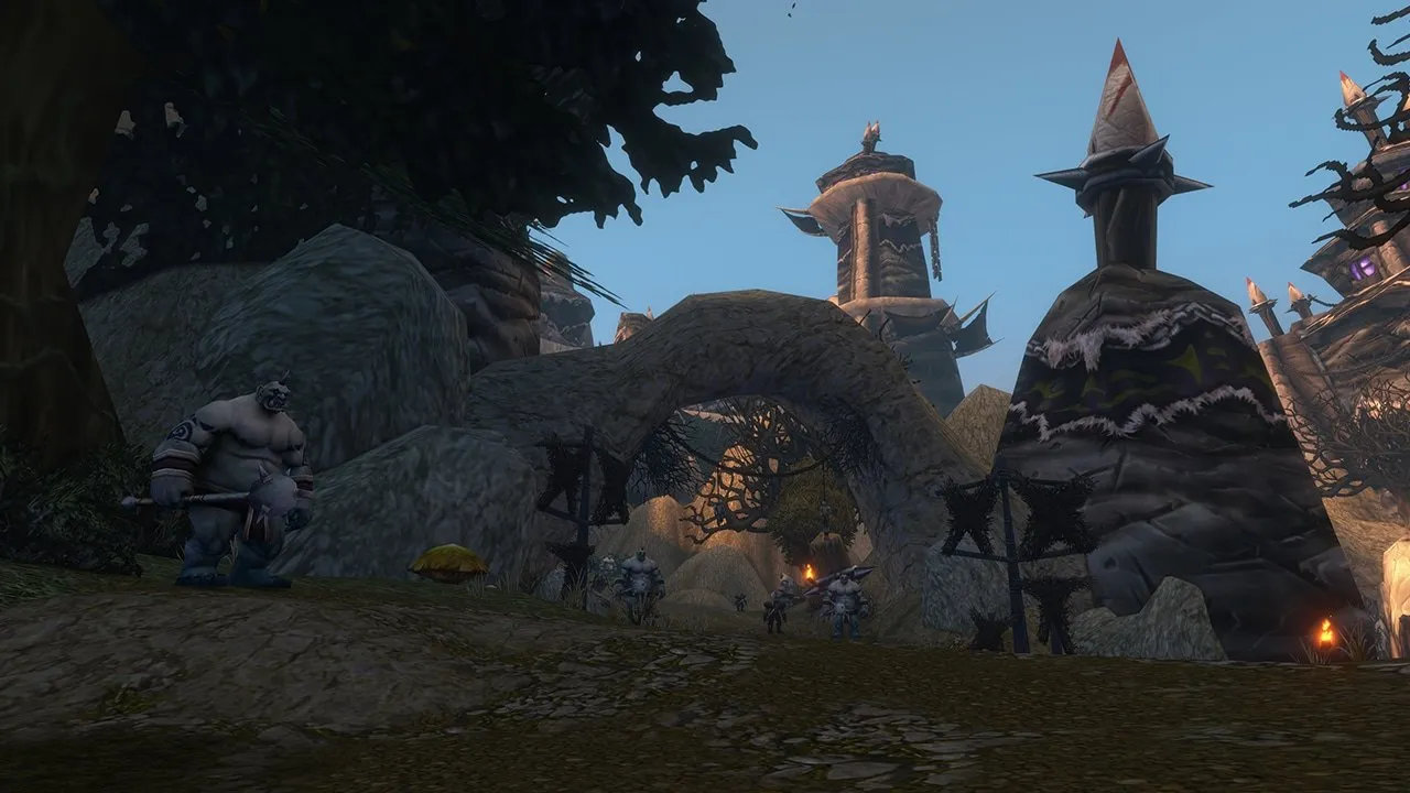 An ogre guarding a stone gate with spiked towers in a forest, an image from Blizzard of World of Warcraft: Forever