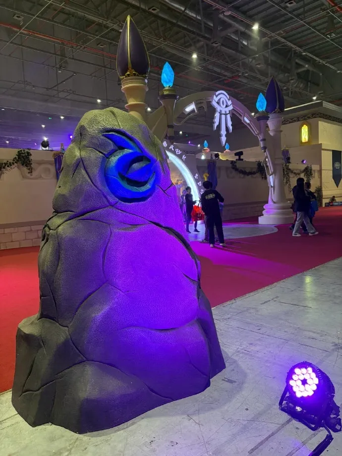 A purple stone with a glowing blue rune in front of an arch with the eye of the Kirin Tor, a photo of the Forever Party in Shanghai