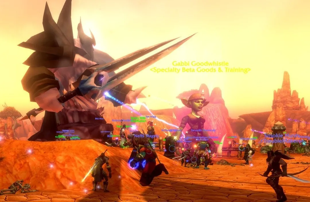 A world boss with a spear next to Gabbi Goodwhistle in a red canyon, with players fighting around them, a screenshot from the beta of World of Warcraft: Forever
