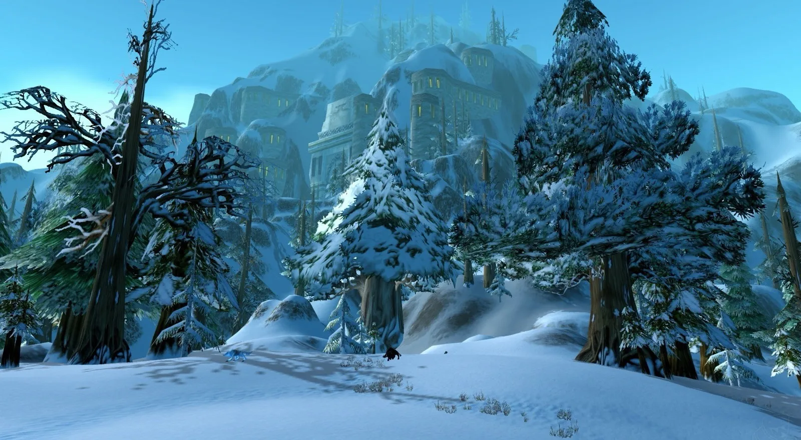 A snowy pine forest in Dun Morogh with a dwarven fortress in the mountains behind it, a screenshot from World of Warcraft